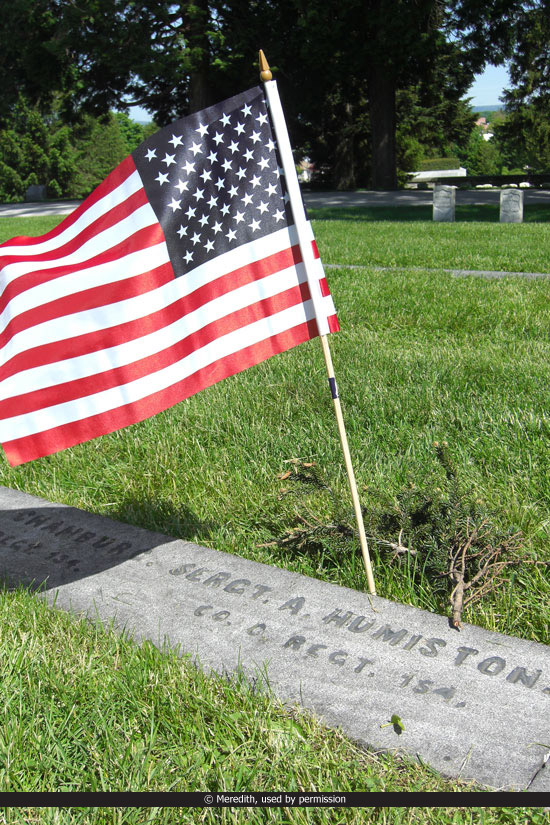 an american flag on the grave of a sergeant