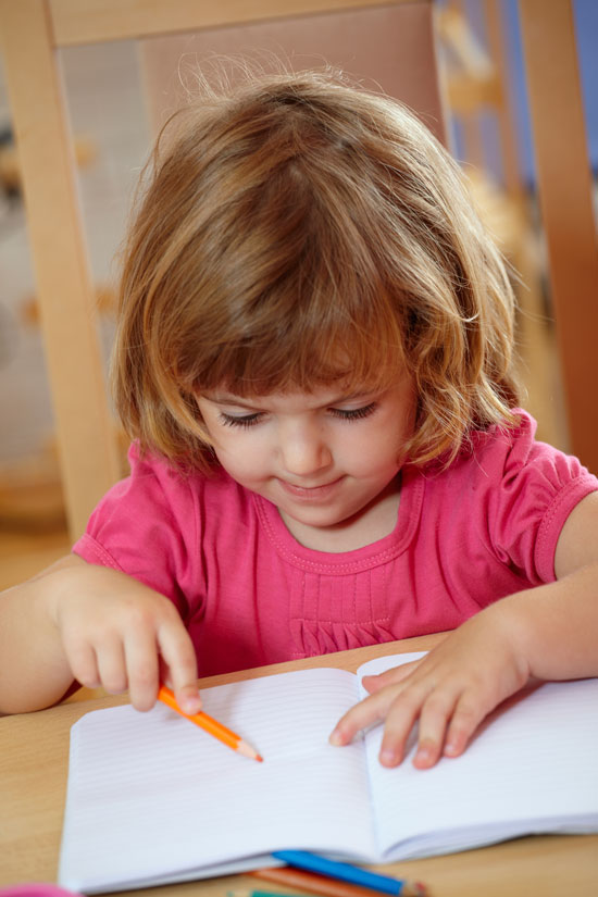 Closeup of cute little girl drawing with color pencils 10415731