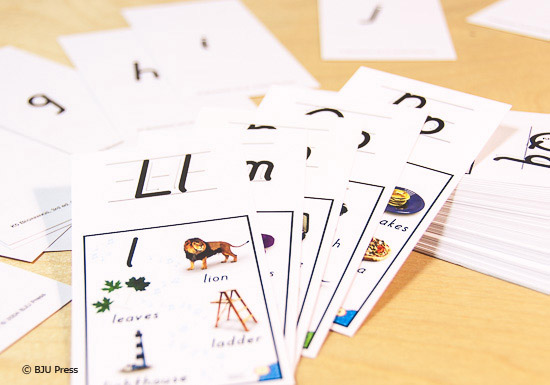 alphabet flashcards spread out on a table