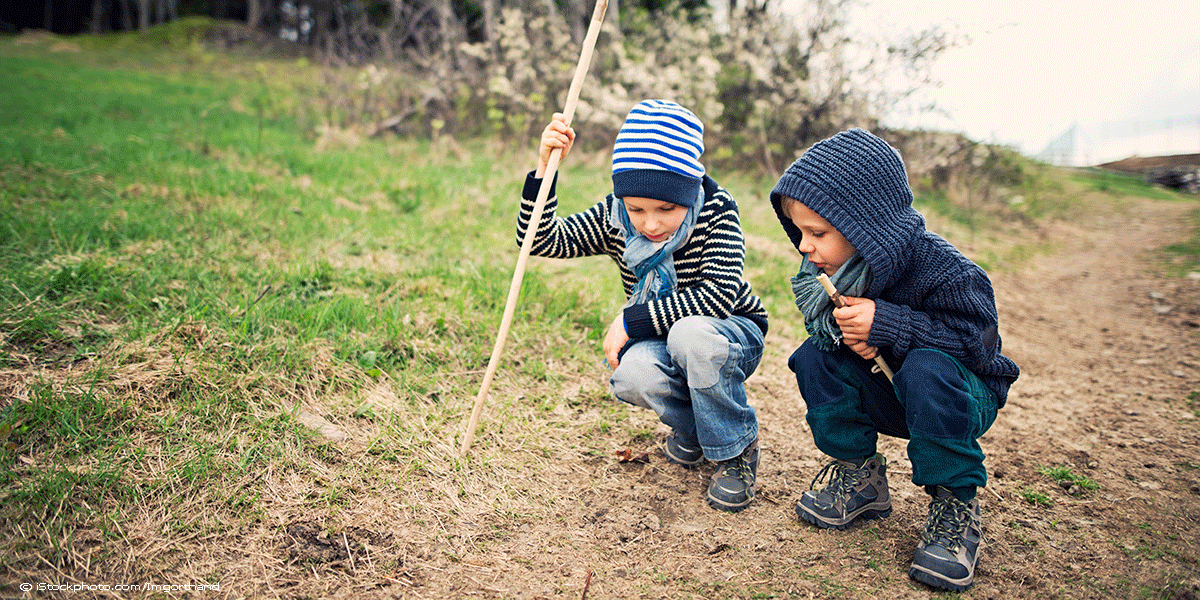 two boys exploring nature