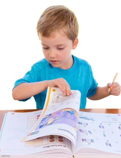 image of young boy working on a BJU Press preschool textbook