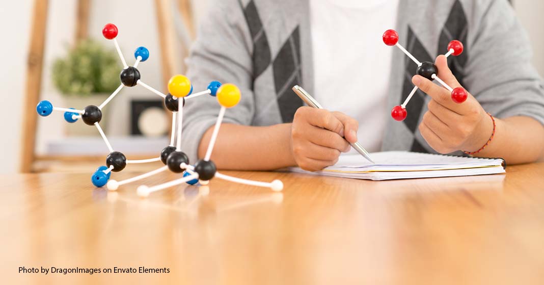 student with chemical formula models 