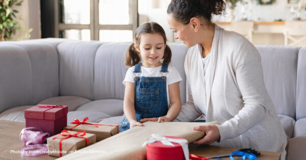 mom with child wrapping gifts