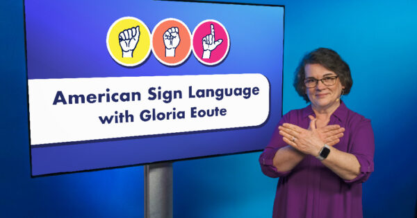 teacher demonstrating an ASL sign