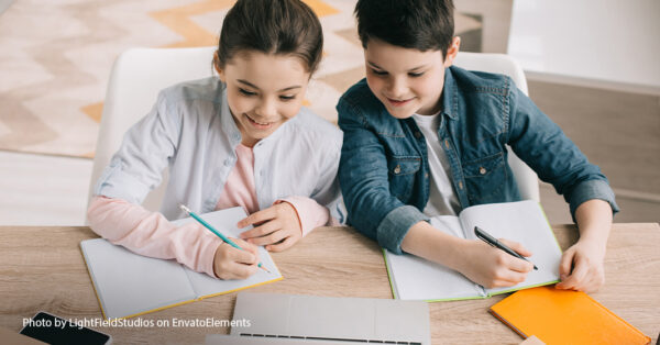 two kids with notebooks