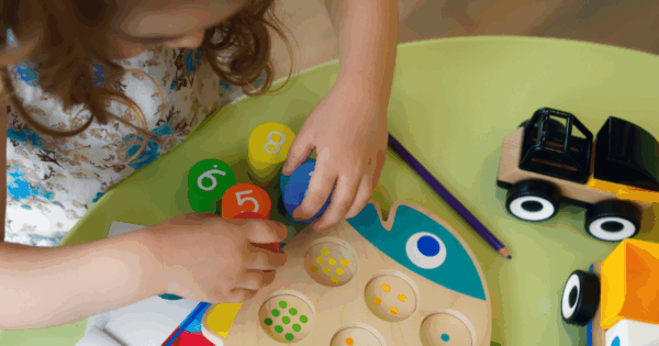 Little girl playing with puzzle